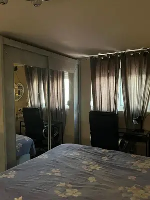 a bedroom with a bed and two chairs and a mirror at Cozy Rhodes Studio in Rhodes Town