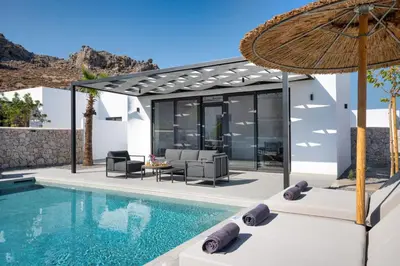 a villa with a swimming pool and a house at Zen Club Luxury Villas in Kolimbia
