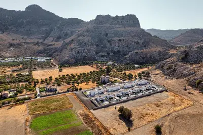 an aerial view of a farm with mountains in the background at Zen Club Luxury Villas in Kolimbia