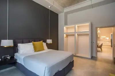 a bedroom with a large bed with yellow pillows at Evie's Oasis in Ixia