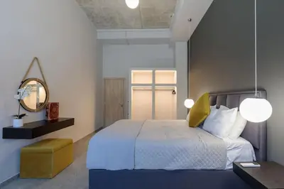 a bedroom with a bed and a mirror and a table at Evie's Oasis in Ixia