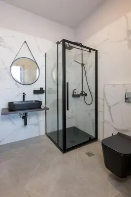 a bathroom with a glass shower and a sink at Evie's Oasis in Ixia