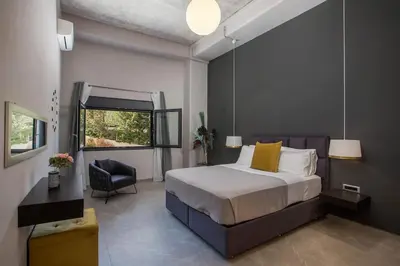 a bedroom with a bed and a chair at Evie's Oasis in Ixia