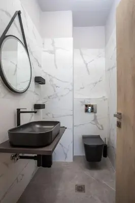 a bathroom with a black sink and a mirror at Evie's Oasis in Ixia