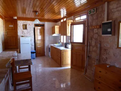 a kitchen with wooden cabinets and a counter top at Nikitas Studio in Halki