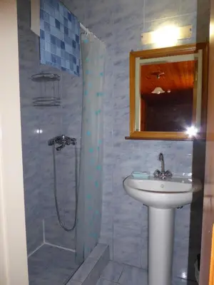 a bathroom with a sink and a shower at Nikitas Studio in Halki