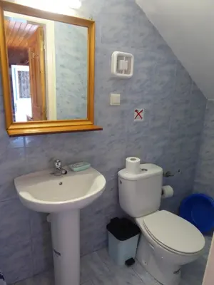 a bathroom with a sink and a toilet and a mirror at Nikitas Studio in Halki
