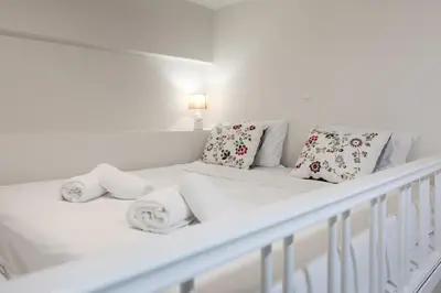 a white bed with towels and pillows on it at Villa Basilio in Gennadi
