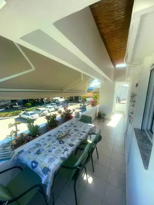 a dining room with a long table and chairs at Niki's House in Haraki