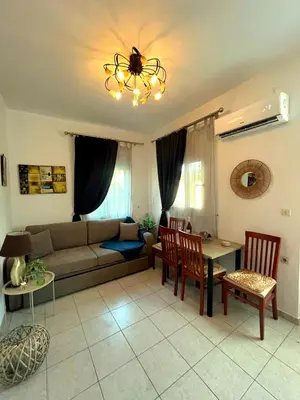 a living room with a couch and a table and chairs at Niki's House in Haraki
