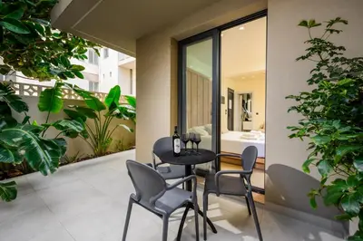 a patio with a table and chairs on a balcony at Monarco Executive Rooms in Rhodes Town
