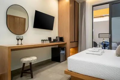 a hotel room with a bed and a mirror at Monarco Executive Rooms in Rhodes Town