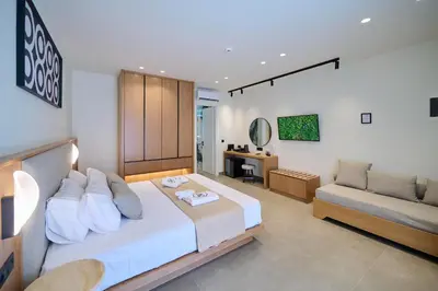a bedroom with a large bed and a couch at Monarco Executive Rooms in Rhodes Town