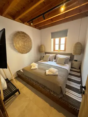 a bedroom with a large bed with towels on it at Tapanis luxury house in Líndos
