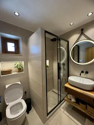 a bathroom with a shower and a toilet and a sink at Tapanis luxury house in Líndos