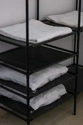 a black bunk bed with white towels on it at Ismini Basement Retreat in vlicha