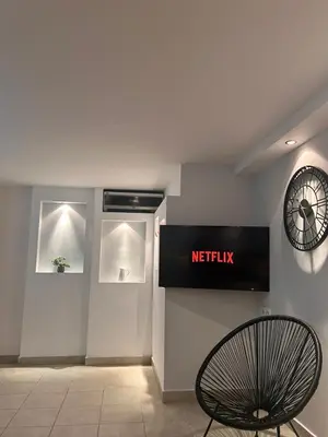 a sign on the wall of a waiting room with a chair at Ismini Basement Retreat in vlicha