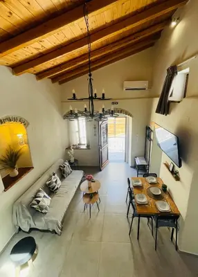 a living room with a couch and a table at Serenity Luxury Apartment in Symi