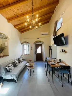 a living room with a couch and a table at Serenity Luxury Apartment in Symi
