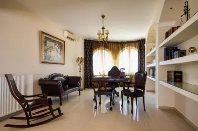 a living room with a table and chairs at Ralu Villa - Faliraki & Traganou Beach in Kalithies