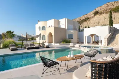 a villa with a swimming pool with chairs and a table at Ralu Villa - Faliraki & Traganou Beach in Kalithies