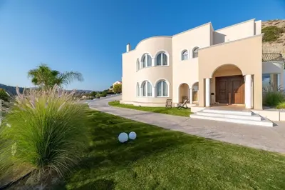 a large white house with two white eggs on the lawn at Ralu Villa - Faliraki & Traganou Beach in Kalithies