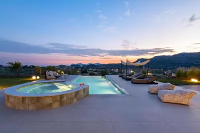 a swimming pool with couches and a patio at Ralu Villa - Faliraki & Traganou Beach in Kalithies