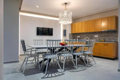 a kitchen and dining room with a table and chairs at Mira Villa - Faliraki & Traganou Beach in Kalithies