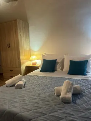 a bedroom with a large bed with towels on it at Zoe House-Old Town in Rhodes Town
