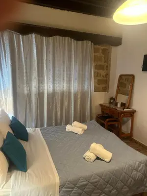 a bedroom with two beds with towels on them at Zoe House-Old Town in Rhodes Town