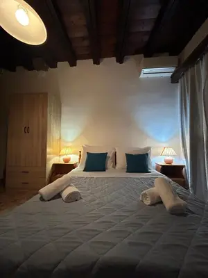 a bedroom with a large bed with two pillows at Zoe House-Old Town in Rhodes Town