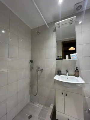 a white bathroom with a sink and a shower at Zoe House-Old Town in Rhodes Town