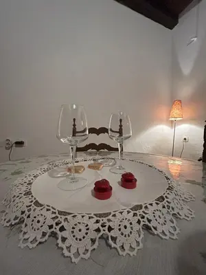 a table with two wine glasses on a white table cloth at Zoe House-Old Town in Rhodes Town