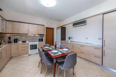 a kitchen with a table and chairs in a room at Thalpori Villa in Pastida