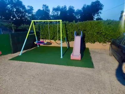 a playground with a slide and a swing at Thalpori Villa in Pastida