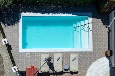 an overhead view of a swimming pool with a camera at Thalpori Villa in Pastida
