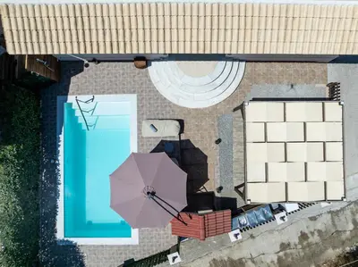 an overhead view of a pool and an umbrella at Thalpori Villa in Pastida