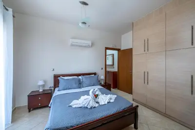 a bedroom with a bed with towels on it at Thalpori Villa in Pastida