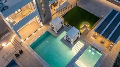 an overhead view of a swimming pool with a lawn at Grand Aqua Luxury Villa by Mintzi in Yennadhion