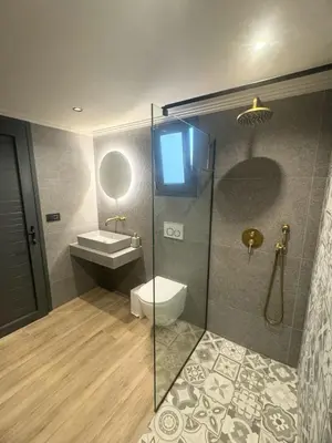 a bathroom with a toilet and a sink and a shower at Grand Aqua Luxury Villa by Mintzi in Yennadhion