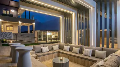 a living room with a couch and a large window at Grand Aqua Luxury Villa by Mintzi in Yennadhion