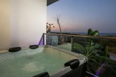a bath tub sitting on top of a balcony at Zafora Apartment in Koskinou