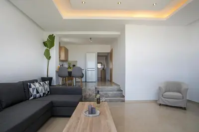 a living room with a couch and a table at Zafora Apartment in Koskinou