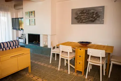 a living room with a wooden table and chairs at Villa Fenia in Gennadi