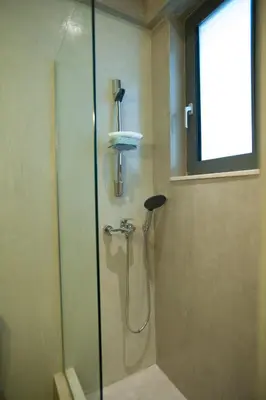 a shower with a glass door in a bathroom at Villa Fenia in Gennadi
