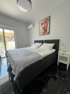 a bedroom with a large bed with a large window at Kyra Maria in Rhodes Town