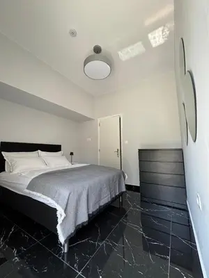 a bedroom with a bed with a black floor at Kyra Maria in Rhodes Town