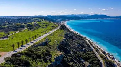 an aerial view of a beach with palm trees at Kyra Maria in Rhodes Town