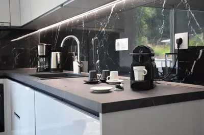 a kitchen counter with a coffee maker and cups on it at Kyra Maria in Rhodes Town