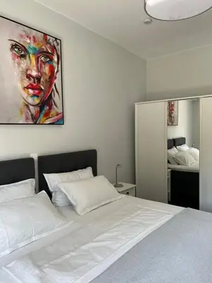 a bedroom with a bed with a painting on the wall at Kyra Maria in Rhodes Town